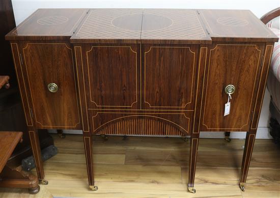 An inlaid rosewood metamorphic cocktail cabinet, in the form of a breakfront commode, W.123cm